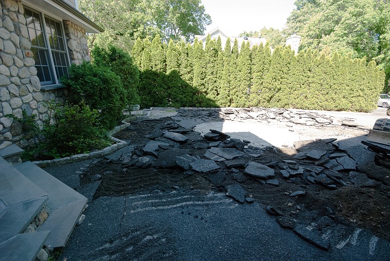 DSC_1763.jpg - The first step in repaving the driveway was breaking up the old asphalt.