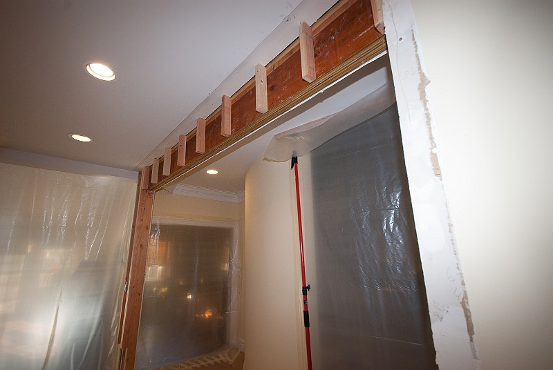 DSC_0910.jpg - The wall build-out continues.  The ceiling LVL next to the butler's pantry is made cosmetically larger.