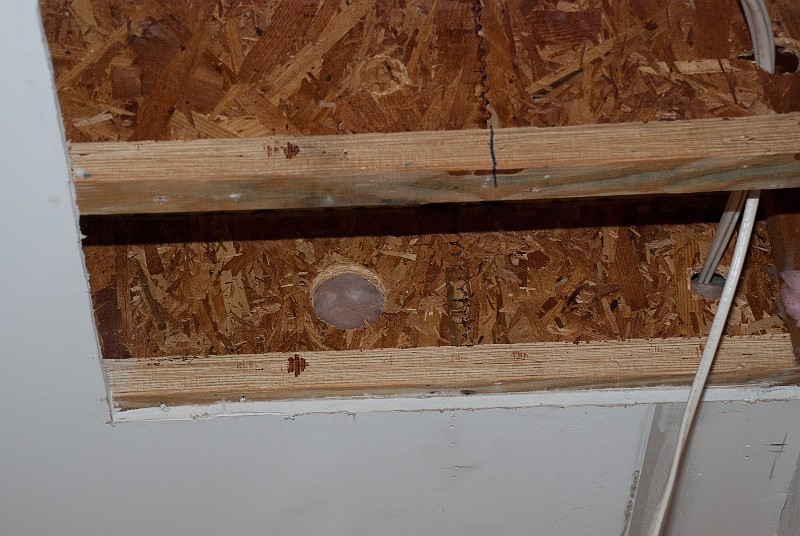 DSC_1236.jpg - And while I was working on the recessed lights I found where somebody must have thought they were running a 3-inch drain through the joists.  Now it's just a hole.  Why on earth?
