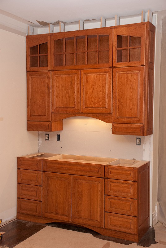DSC_1259.jpg - The buffet area cabinets required a great deal of scribing and trimming on their left sides to properly fit the corner.  I re-installed the under-cabinet LED light fixture on the upper cabinet and restored the power.