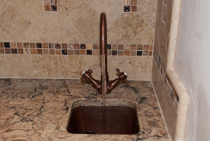 DSC_1456.jpg - The copper bar sink faucet that Jayne found was a little tricky to plumb because of it's Euro-metric supply hose connections.  With some clever transition pieces, I can turn the handles and the water flows fine.
